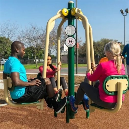 Adults using Fitness Park equipment.