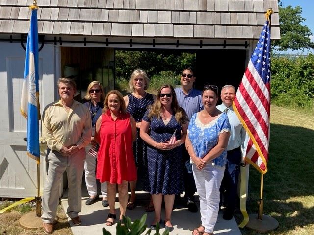 Officials gather at the restored barn