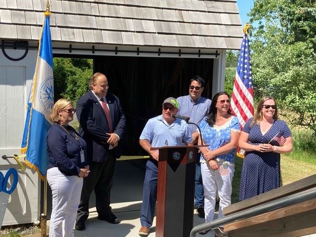 Officials speaking at the restored barn